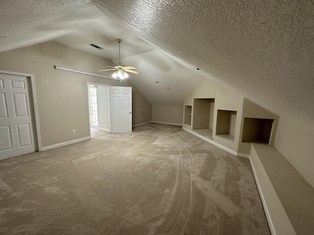 1906 Carolyn Dr, Jonesboro, AR 72404 - additional living space featuring lofted ceiling, light colored carpet, visible vents, and a textured ceiling