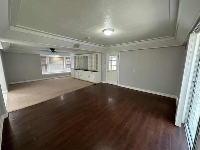 1906 Carolyn Dr, Jonesboro, AR 72404 - unfurnished living room featuring a textured ceiling, baseboards, and a healthy amount of sunlight