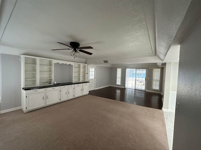 1906 Carolyn Dr, Jonesboro, AR 72404 - unfurnished living room featuring a textured ceiling, ceiling fan, crown molding, baseboards, and dark carpet