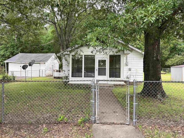bungalow-style house featuring a fenced front yard, a gate, and a front yard