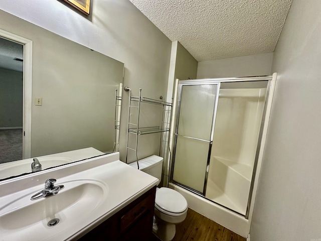 12921 Barth Rd, Alexander, AR 72002 - bathroom with a shower with shower door, a textured ceiling, wood finished floors, toilet, and vanity