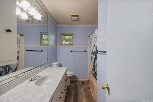 bathroom featuring toilet, wood finished floors, visible vents, vanity, and ornamental molding