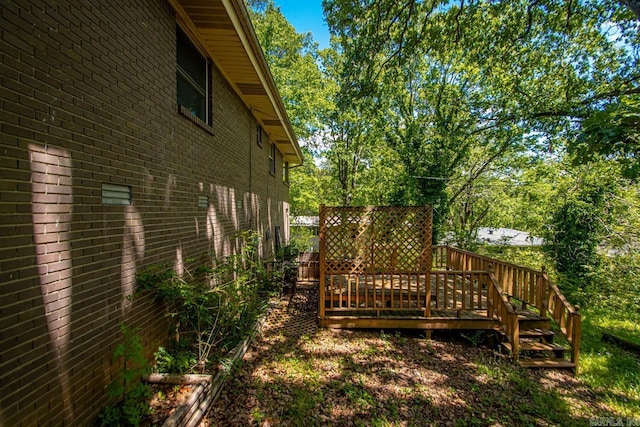 exterior space with brick siding and a deck