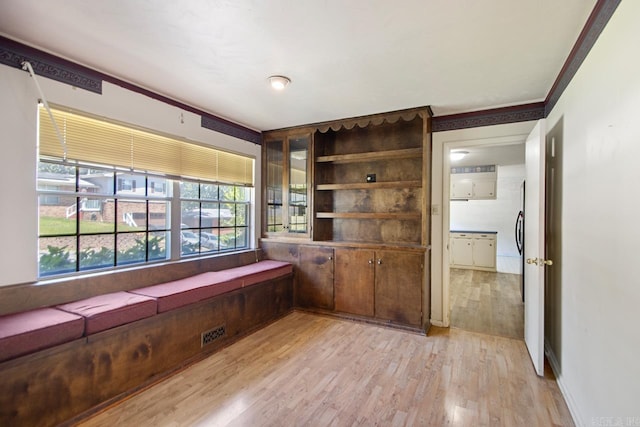 spare room featuring light wood finished floors and visible vents