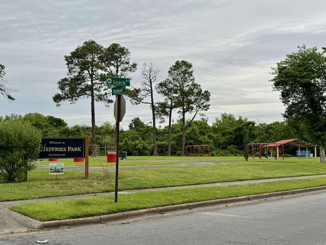view of property's community with a yard and playground community