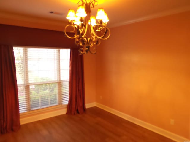 2808 Valley Park, Little Rock, AR 72212 - empty room featuring baseboards, a chandelier, crown molding, and wood finished floors