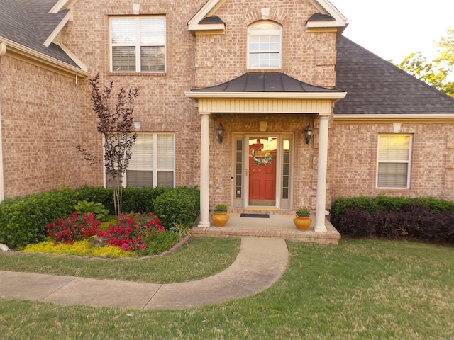2808 Valley Park, Little Rock, AR 72212 - view of exterior entry with a yard, roof with shingles, a standing seam roof, and brick siding