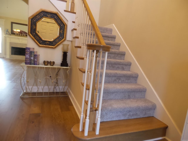 2808 Valley Park, Little Rock, AR 72212 - stairs featuring baseboards, a fireplace, and wood finished floors