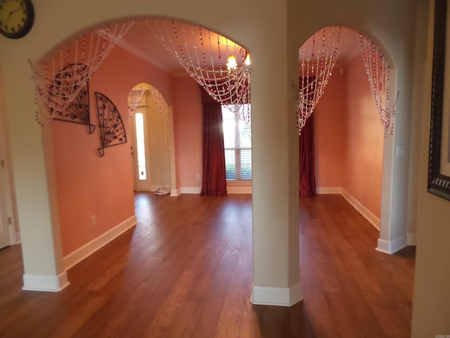2808 Valley Park, Little Rock, AR 72212 - unfurnished dining area featuring a chandelier, arched walkways, baseboards, and wood finished floors