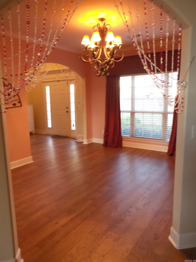 2808 Valley Park, Little Rock, AR 72212 - interior space with arched walkways, baseboards, an inviting chandelier, and wood finished floors
