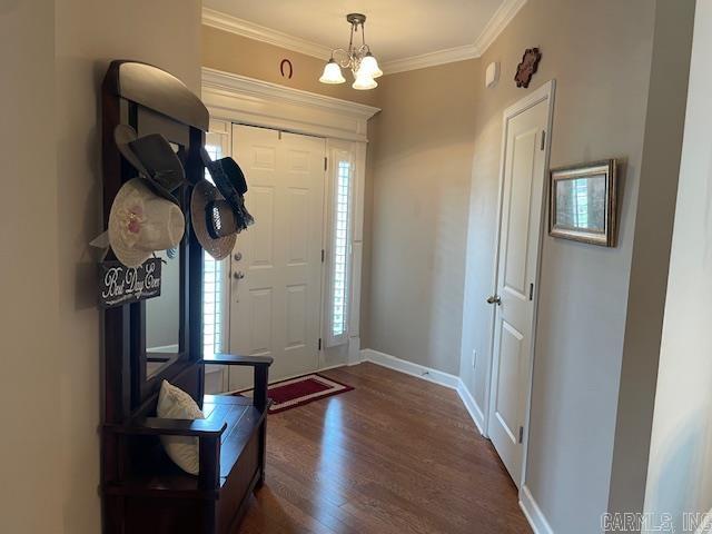 2241 Sage Meadows Cir, Sherwood, AR 72120 - foyer entrance featuring crown molding, dark wood finished floors, a chandelier, and baseboards