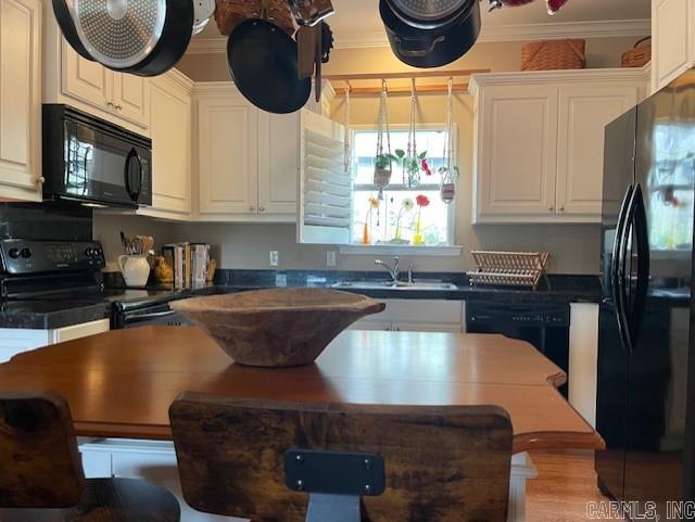 2241 Sage Meadows Cir, Sherwood, AR 72120 - kitchen featuring a sink, black appliances, crown molding, white cabinetry, and dark countertops