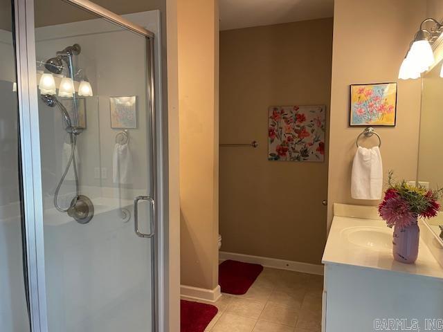 2241 Sage Meadows Cir, Sherwood, AR 72120 - full bath featuring vanity, tile patterned flooring, a shower stall, and toilet