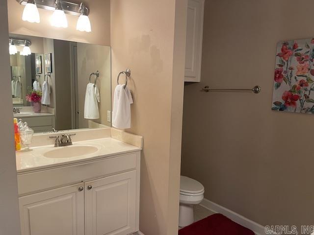 2241 Sage Meadows Cir, Sherwood, AR 72120 - bathroom featuring vanity, toilet, and baseboards