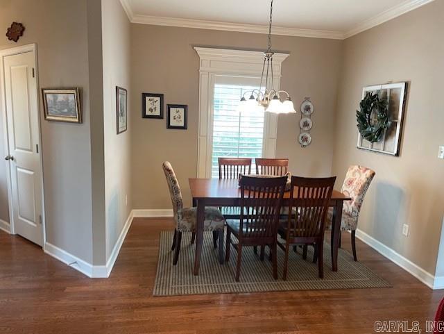 2241 Sage Meadows Cir, Sherwood, AR 72120 - dining space with a chandelier, ornamental molding, baseboards, and wood finished floors