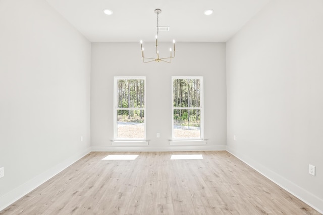 54 Lieblong Rd, Greenbrier, AR 72058 - spare room with light wood-type flooring, baseboards, and a notable chandelier