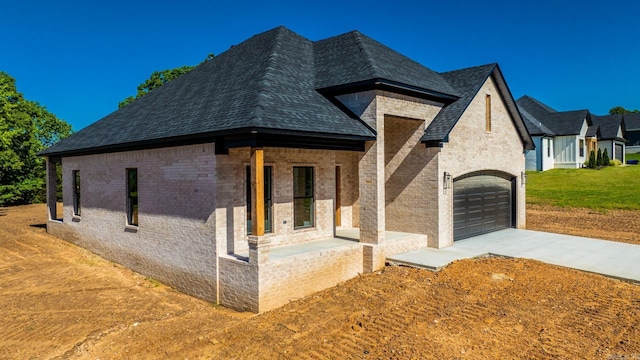 54 Lieblong Rd, Greenbrier, AR 72058 - view of front of property featuring a porch, an attached garage, brick siding, and driveway