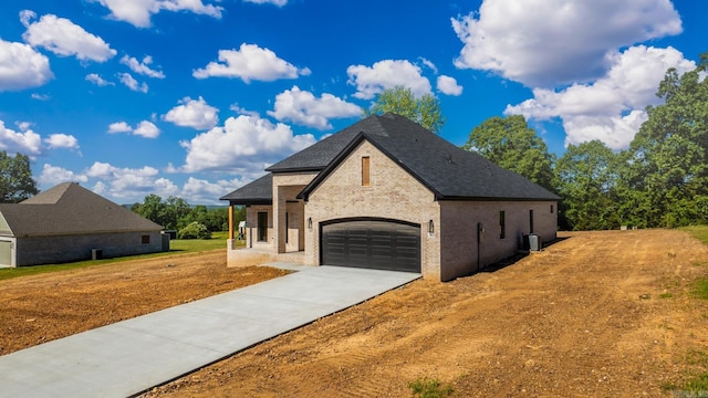 54 Lieblong Rd, Greenbrier, AR 72058 - french provincial home featuring an attached garage, brick siding, and driveway