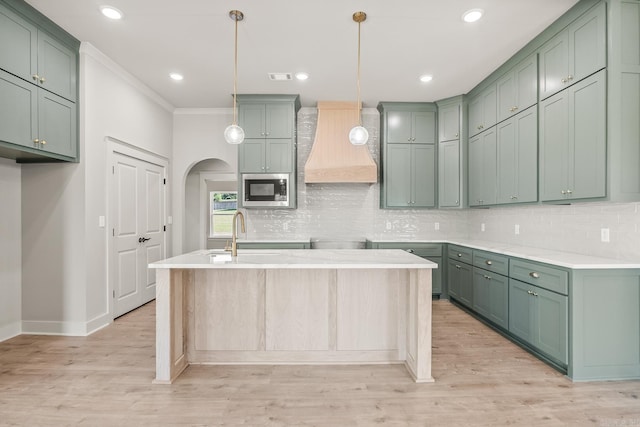 54 Lieblong Rd, Greenbrier, AR 72058 - kitchen featuring baseboards, custom exhaust hood, a sink, stainless steel microwave, and decorative backsplash