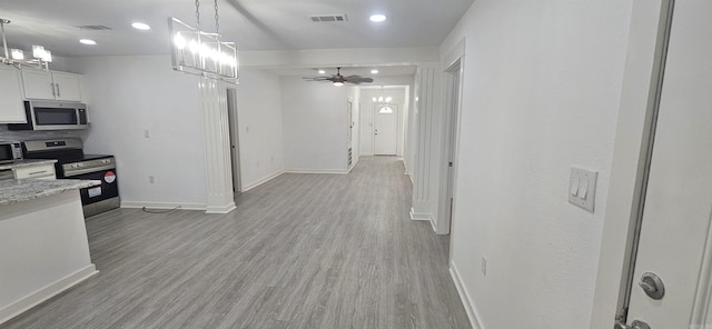 2720 S Spring St, Little Rock, AR 72206 - kitchen with light wood finished floors, pendant lighting, visible vents, baseboards, and appliances with stainless steel finishes