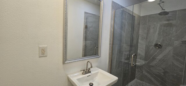 2720 S Spring St, Little Rock, AR 72206 - full bath with a textured wall, a stall shower, and a sink