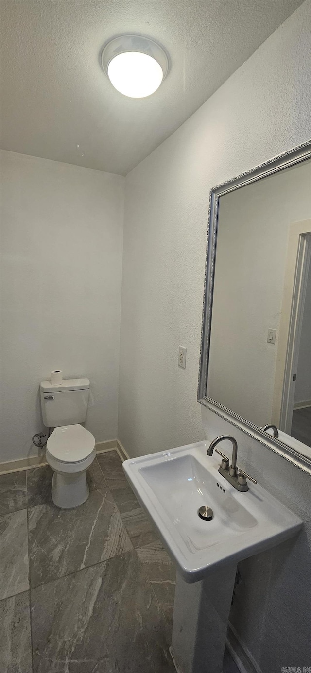 2720 S Spring St, Little Rock, AR 72206 - bathroom featuring toilet, a textured ceiling, and a sink