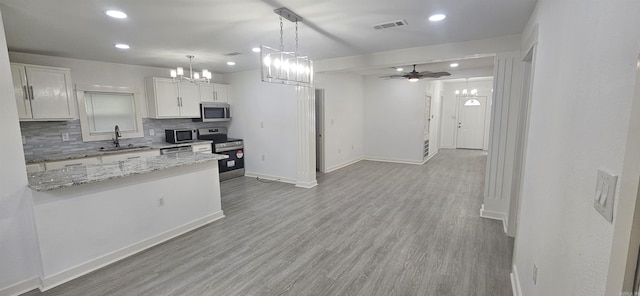 2720 S Spring St, Little Rock, AR 72206 - kitchen with recessed lighting, visible vents, a sink, decorative backsplash, and stainless steel appliances