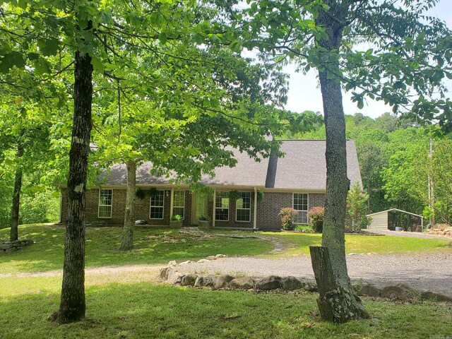 137 Gone Fishin Ln, Mena, AR 71953 - view of front of property featuring a front yard, brick siding, a shingled roof, and driveway