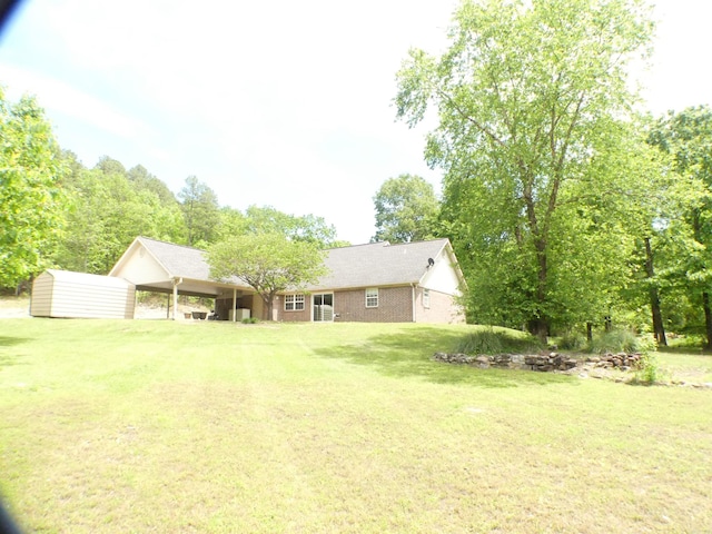 137 Gone Fishin Ln, Mena, AR 71953 - rear view of house with a yard, a carport, and brick siding