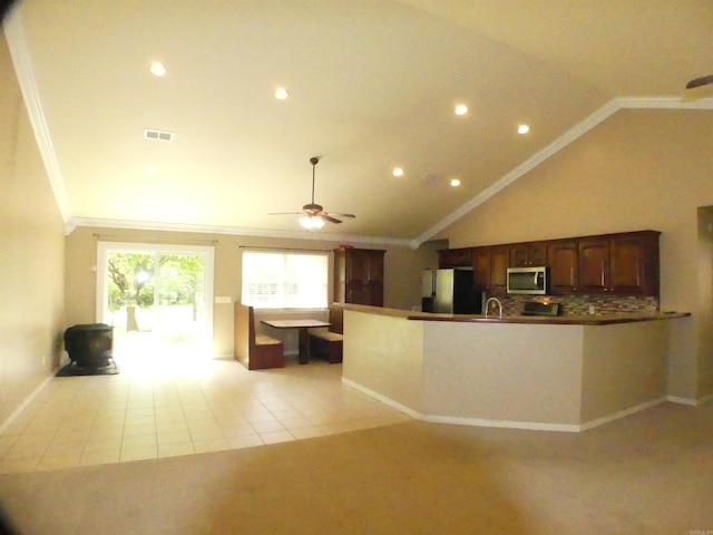 137 Gone Fishin Ln, Mena, AR 71953 - kitchen featuring stainless steel microwave, crown molding, freestanding refrigerator, recessed lighting, and a peninsula