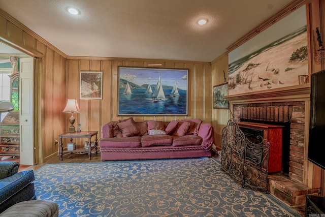 5 Southern Pines Cv, Pine Bluff, AR 71603 - living area featuring ornamental molding, wood walls, a fireplace, and a textured ceiling