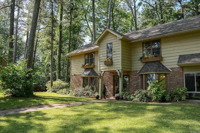 5 Southern Pines Cv, Pine Bluff, AR 71603 - view of front of house with roof with shingles, brick siding, and a front lawn