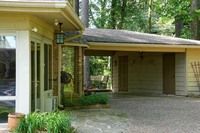 5 Southern Pines Cv, Pine Bluff, AR 71603 - view of exterior entry with roof with shingles and driveway