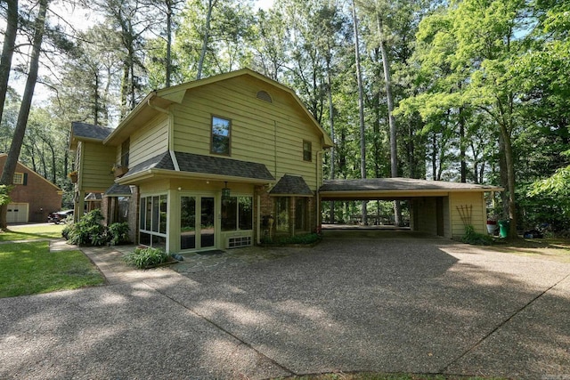 5 Southern Pines Cv, Pine Bluff, AR 71603 - exterior space featuring driveway, brick siding, a shingled roof, and a carport