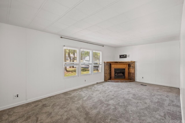 1504 W Woodson Lateral Rd, Hensley, AR 72065 - unfurnished living room featuring carpet flooring, a fireplace with raised hearth, and visible vents