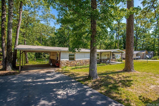 1504 W Woodson Lateral Rd, Hensley, AR 72065 - ranch-style home with stone siding, covered porch, driveway, and a front yard