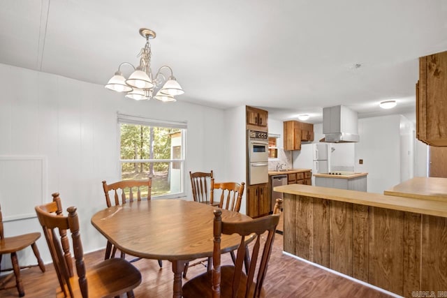 1504 W Woodson Lateral Rd, Hensley, AR 72065 - dining room featuring a chandelier and wood finished floors