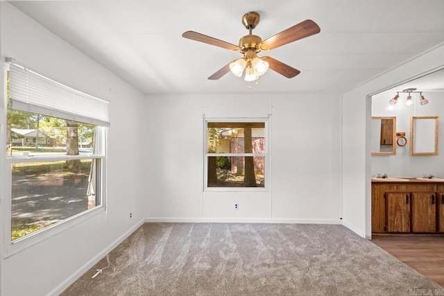 1504 W Woodson Lateral Rd, Hensley, AR 72065 - unfurnished bedroom with baseboards, connected bathroom, a ceiling fan, and carpet