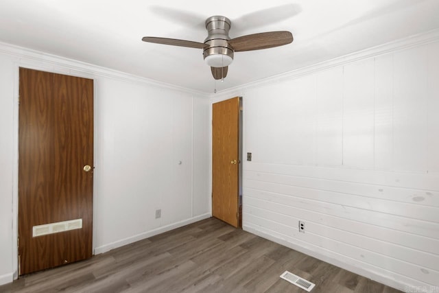 1504 W Woodson Lateral Rd, Hensley, AR 72065 - unfurnished room with wood finished floors, visible vents, crown molding, a ceiling fan, and baseboards