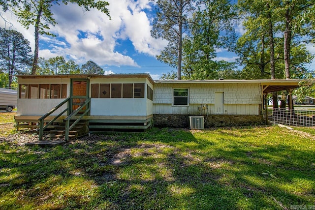 1504 W Woodson Lateral Rd, Hensley, AR 72065 - rear view of property with central AC unit, a sunroom, fence, and a lawn