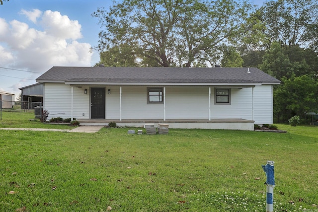 ranch-style home with covered porch, fence, and a front yard