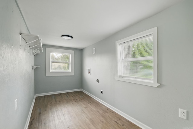 washroom with wood finished floors, electric dryer hookup, laundry area, washer hookup, and baseboards
