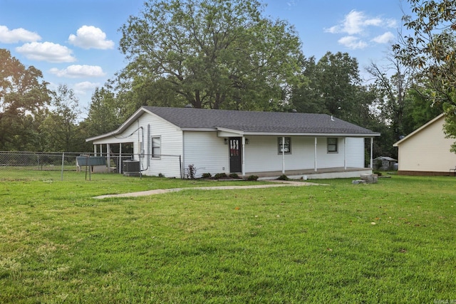 exterior space with a yard, cooling unit, and fence