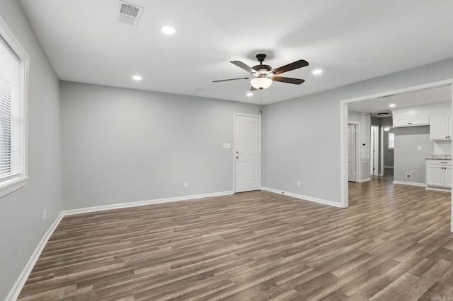 unfurnished living room with wood finished floors, a ceiling fan, and recessed lighting