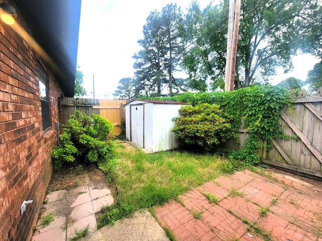 301 Hammond Unit A3, Hot Springs, AR 71913 - view of yard featuring a patio area, an outbuilding, a fenced backyard, and a storage unit