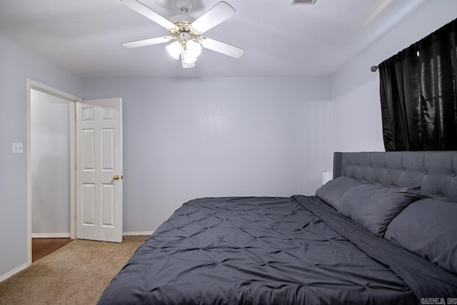 carpeted bedroom with ceiling fan, baseboards, and visible vents