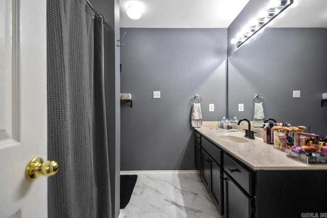 full bath featuring vanity, a shower with curtain, baseboards, and marble finish floor