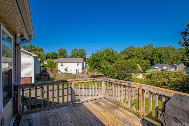 deck featuring fence and a residential view