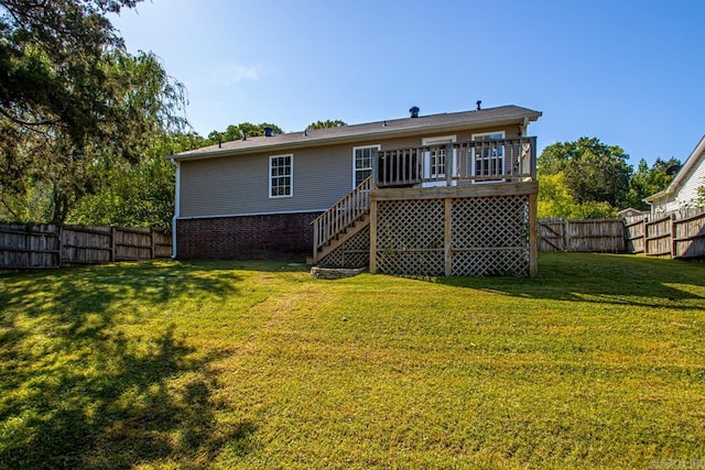 rear view of house with a fenced backyard, stairs, a wooden deck, and a yard
