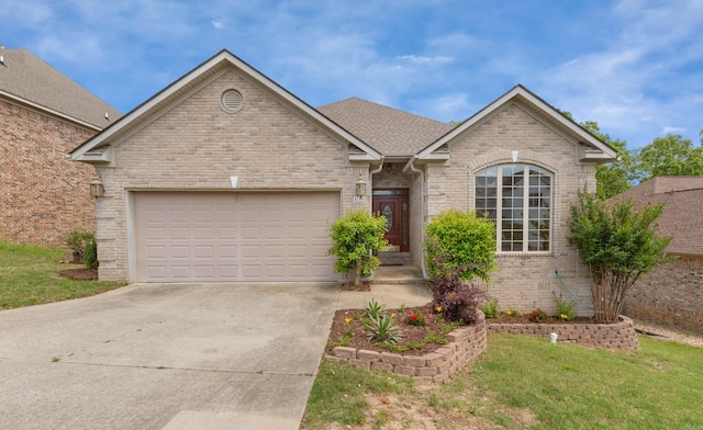 single story home featuring a front lawn, driveway, brick siding, and a garage